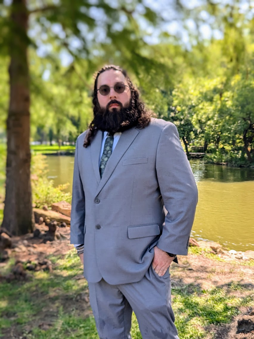 Nich Poole outdoors in a gray suit
